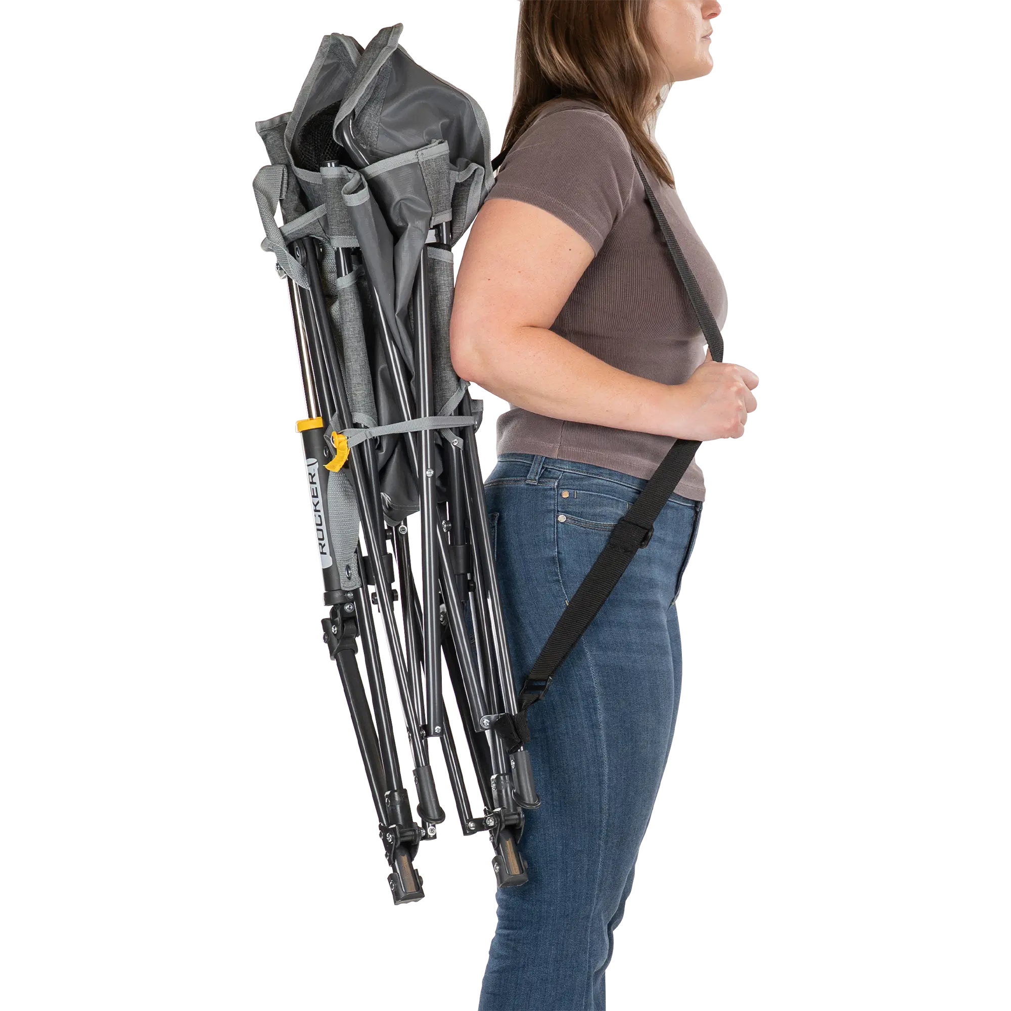 Person using the shoulder strap to carry the gray kickback rocker chair.