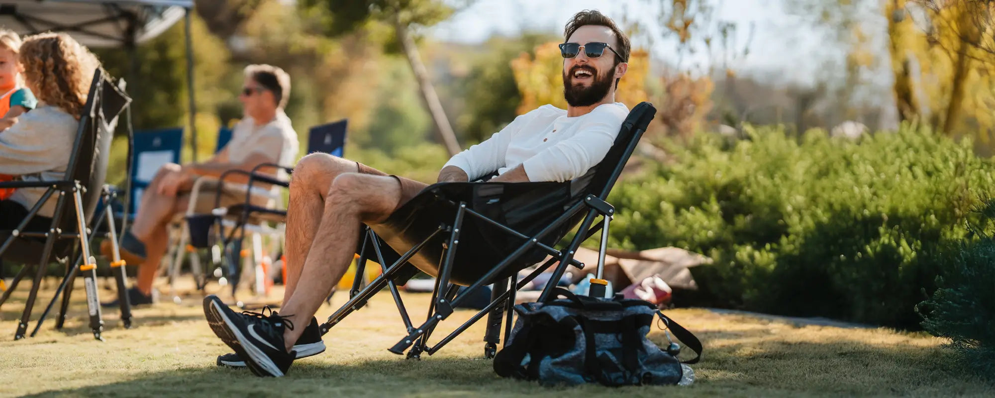 A man smiling while watching a game and sitting in a comfort pro rocker.