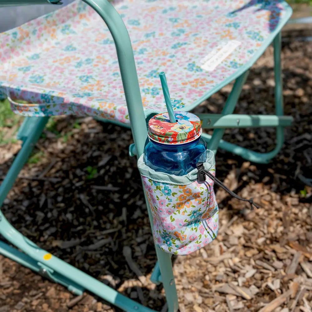 A mason jar in the attached cup holder of the teal sundress freestyle rocker elite.