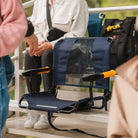 Rich blue Stadium Rock-Cliner set up on bleachers with mesh backrest.