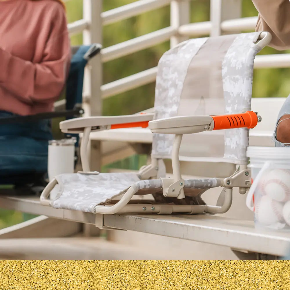 An up close shot of the snow camo stadium rock-cliner positioned on a bleacher.