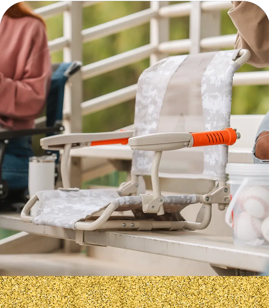 An up close shot of the snow camo stadium rock-cliner positioned on a bleacher.