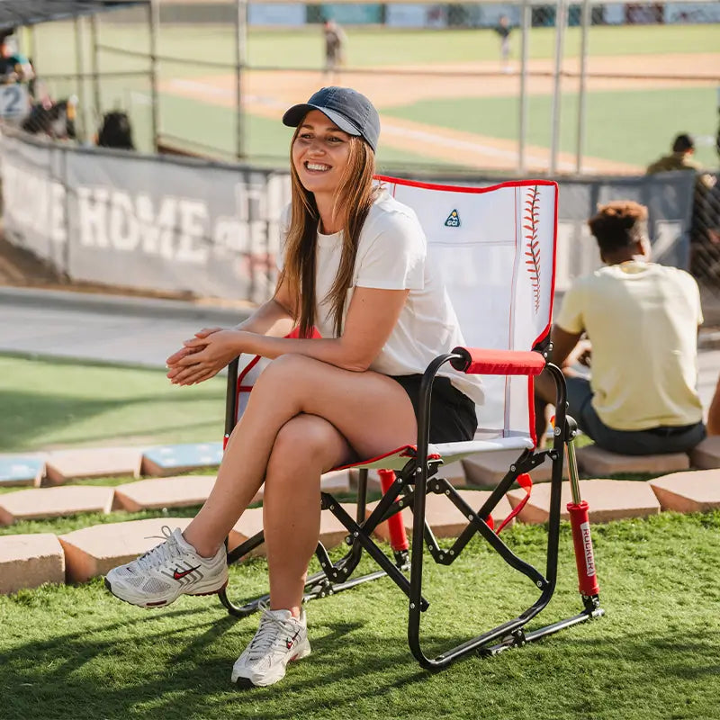 Woman sitting on a baseball-themed chair at a sports event