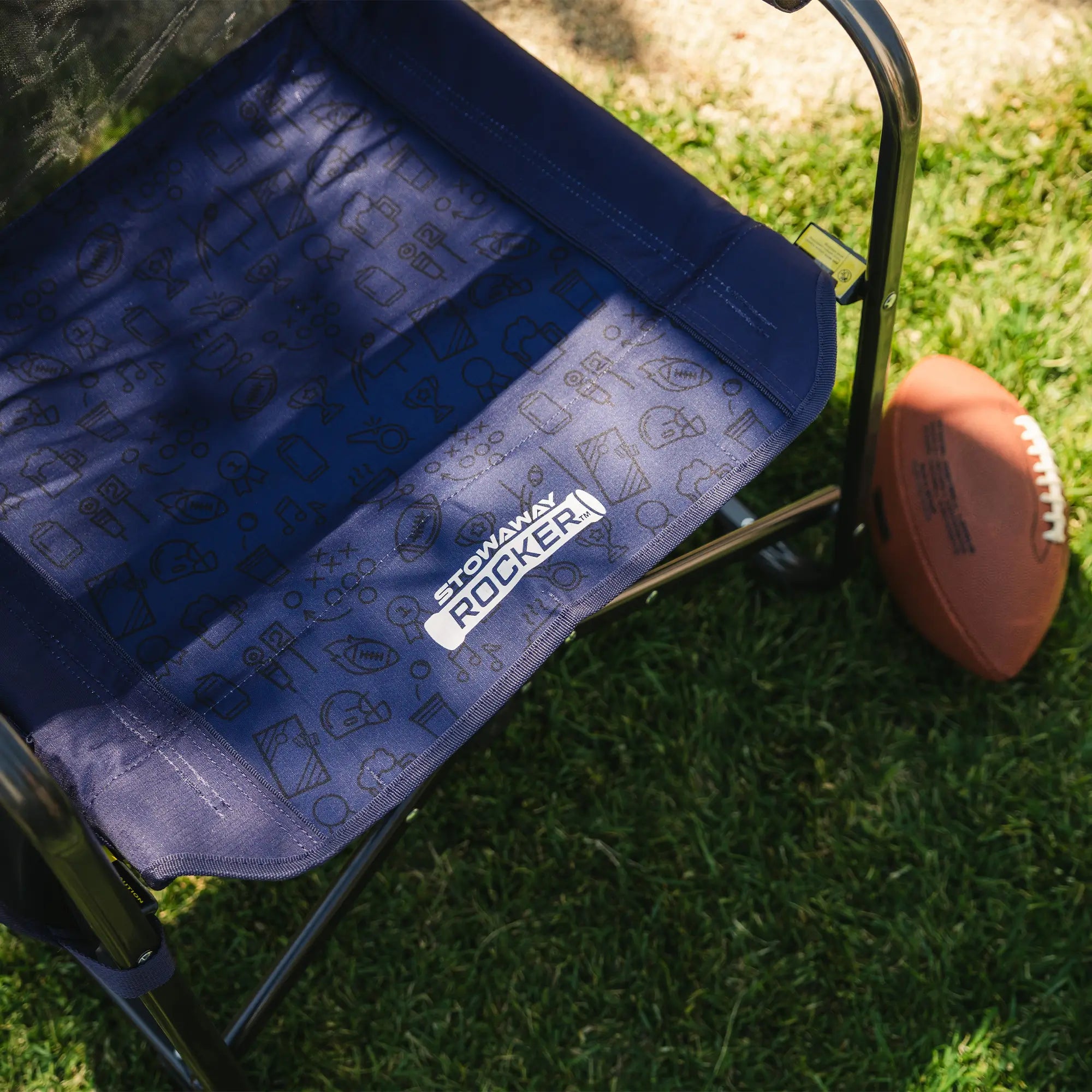 An up-close of the blue tailgater patterned print on the seat of the stowaway rocker.