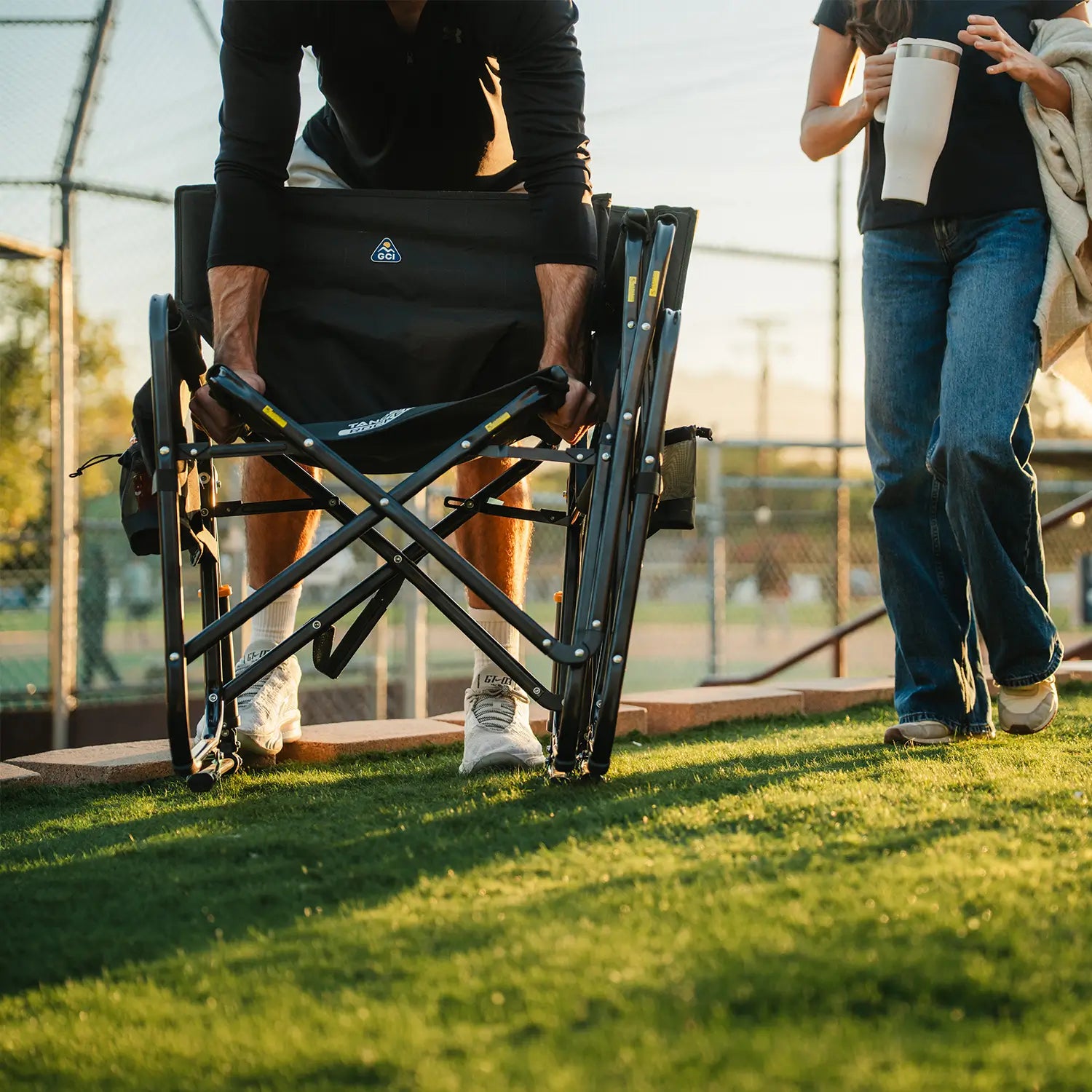 A man unfolding the Tandem Rocker into two seats using the eazy-fold technology.