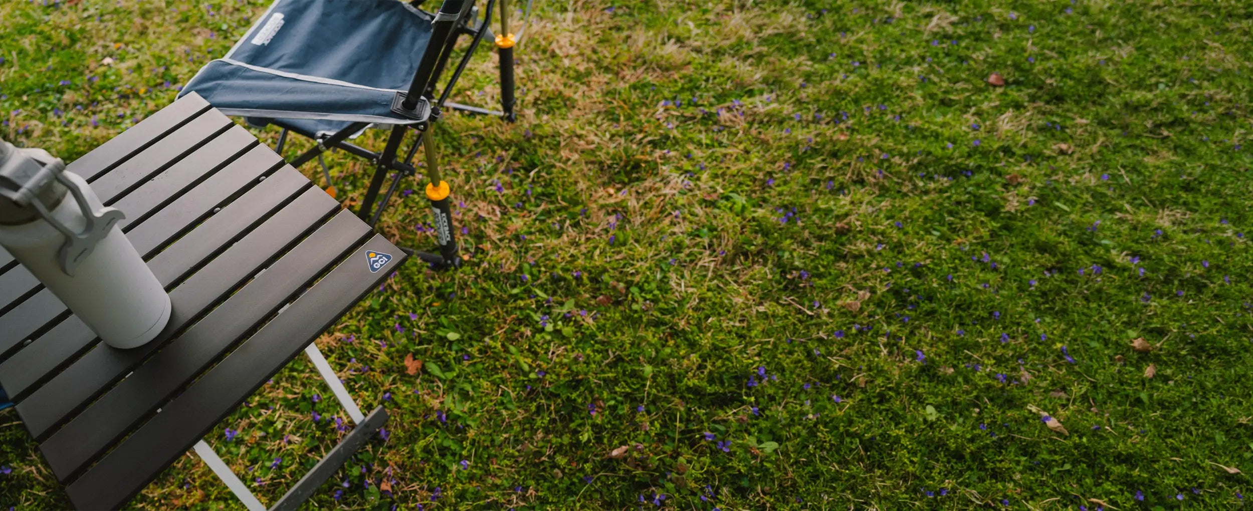 A top view of the Compact Camp Table 20 with a water bottle positioned on the table. 