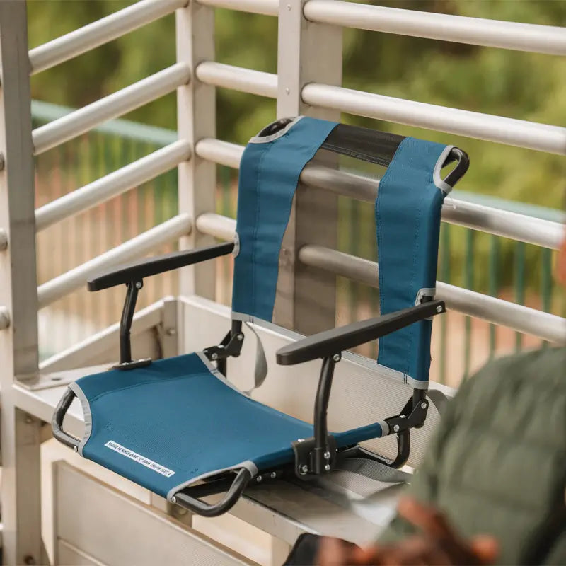 all-groups, Blue Big Comfort Stadium Seat with armrests secured to a bleacher.