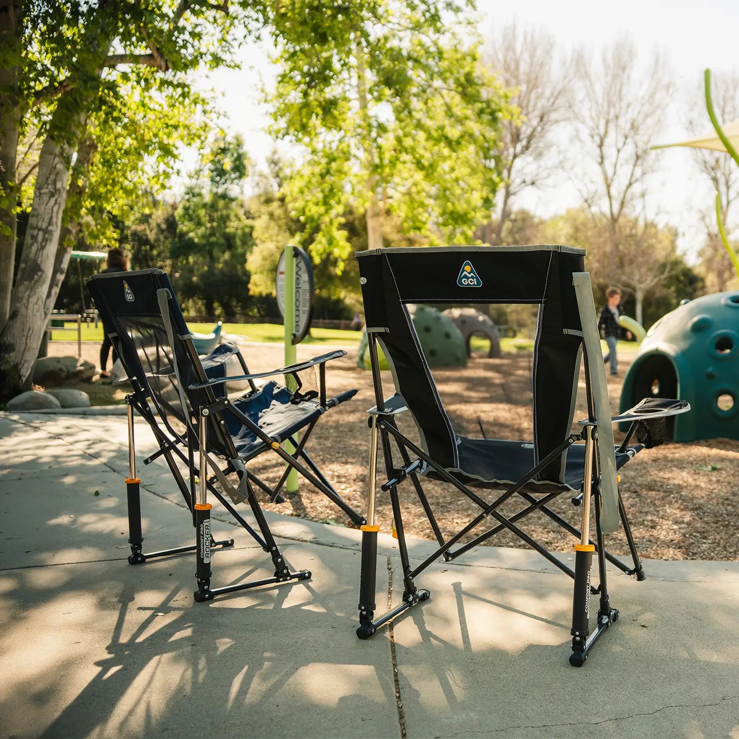 Two Comfort Pro Rocker chairs facing a playground area. 