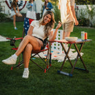 A woman eating chips while sitting in a USA Comfort Pro Rocker. 
