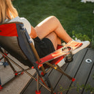 A beverage positioned in the cup holder of a USA Comfort Pro Rocker. 