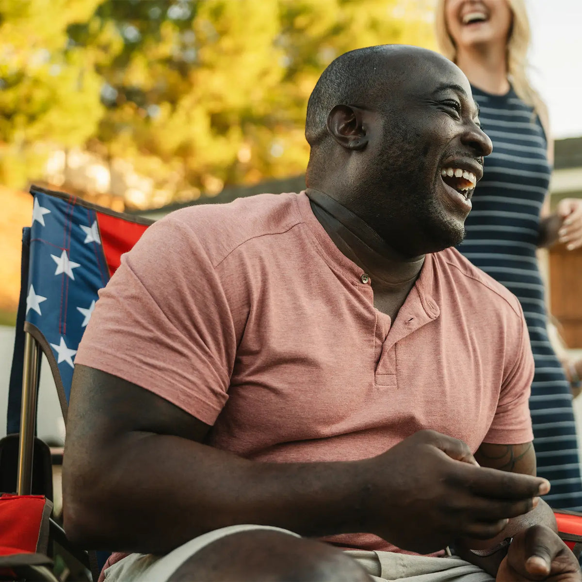 A man is laughing while sitting in a USA Comfort Pro Rocker. 