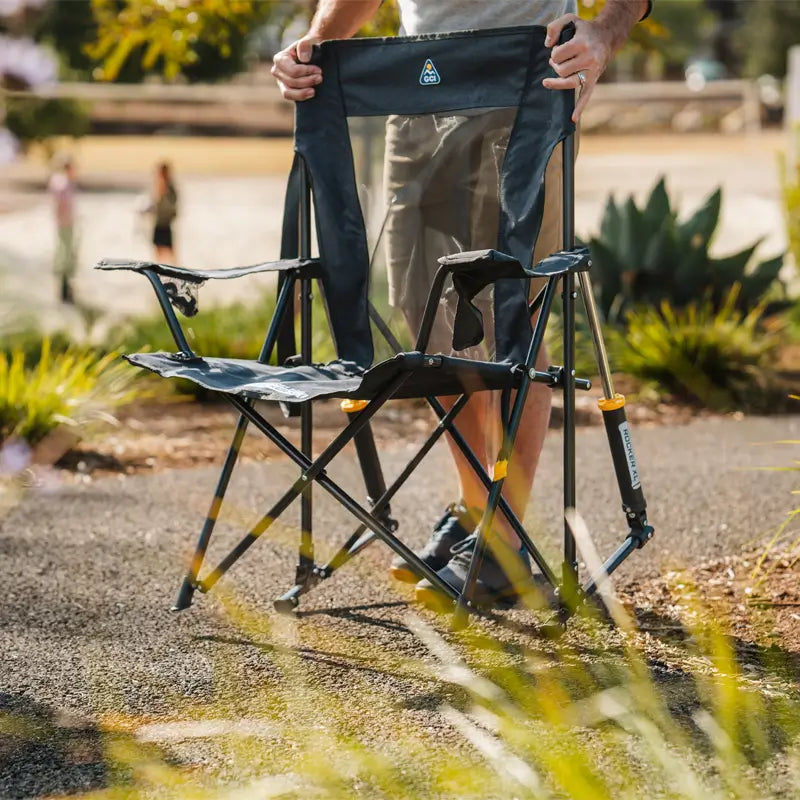 Close-up of the Heathered Charcoal Comfort Pro Rocker XL with a mesh back and drink in the cupholder.