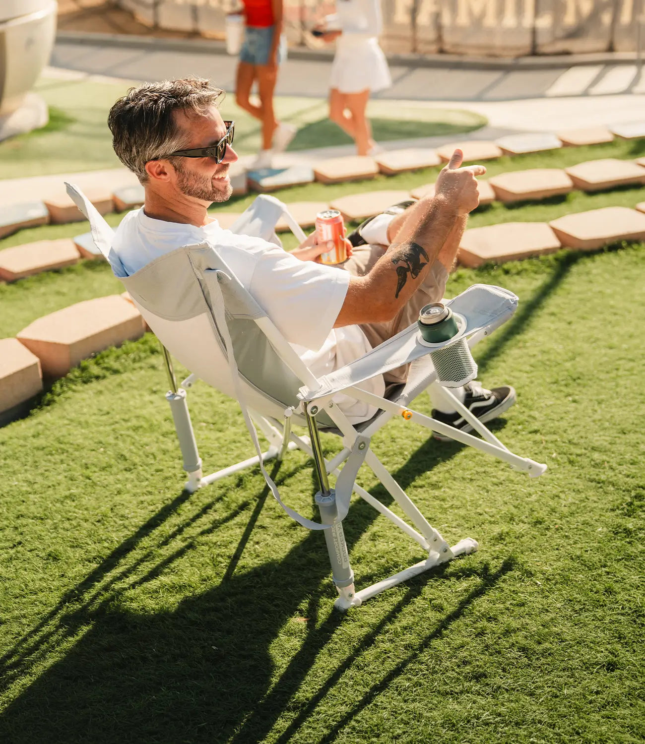 A man rocking in a heathered light blue Comfort Pro Rocker XL at a baseball game. 