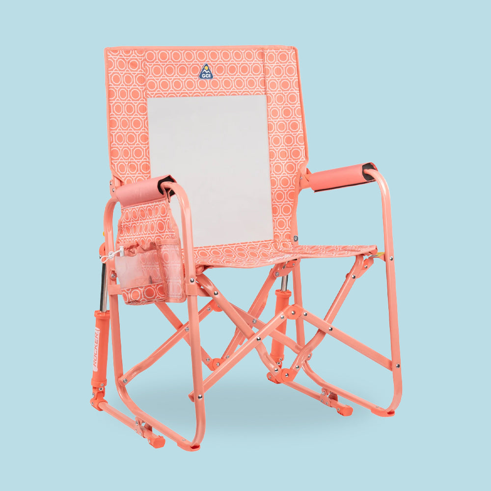 A coral Stowaway Rocker in front of a blue background. 