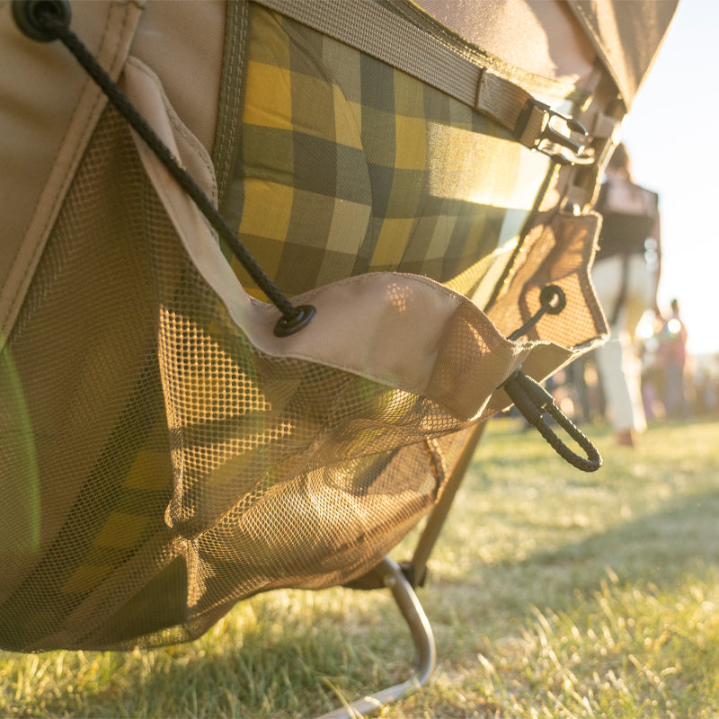 A close-up of the Everywhere Chair 2 mesh storage pocket, showing a secure drawstring closure. The breathable mesh design provides convenient storage for small items at outdoor events.