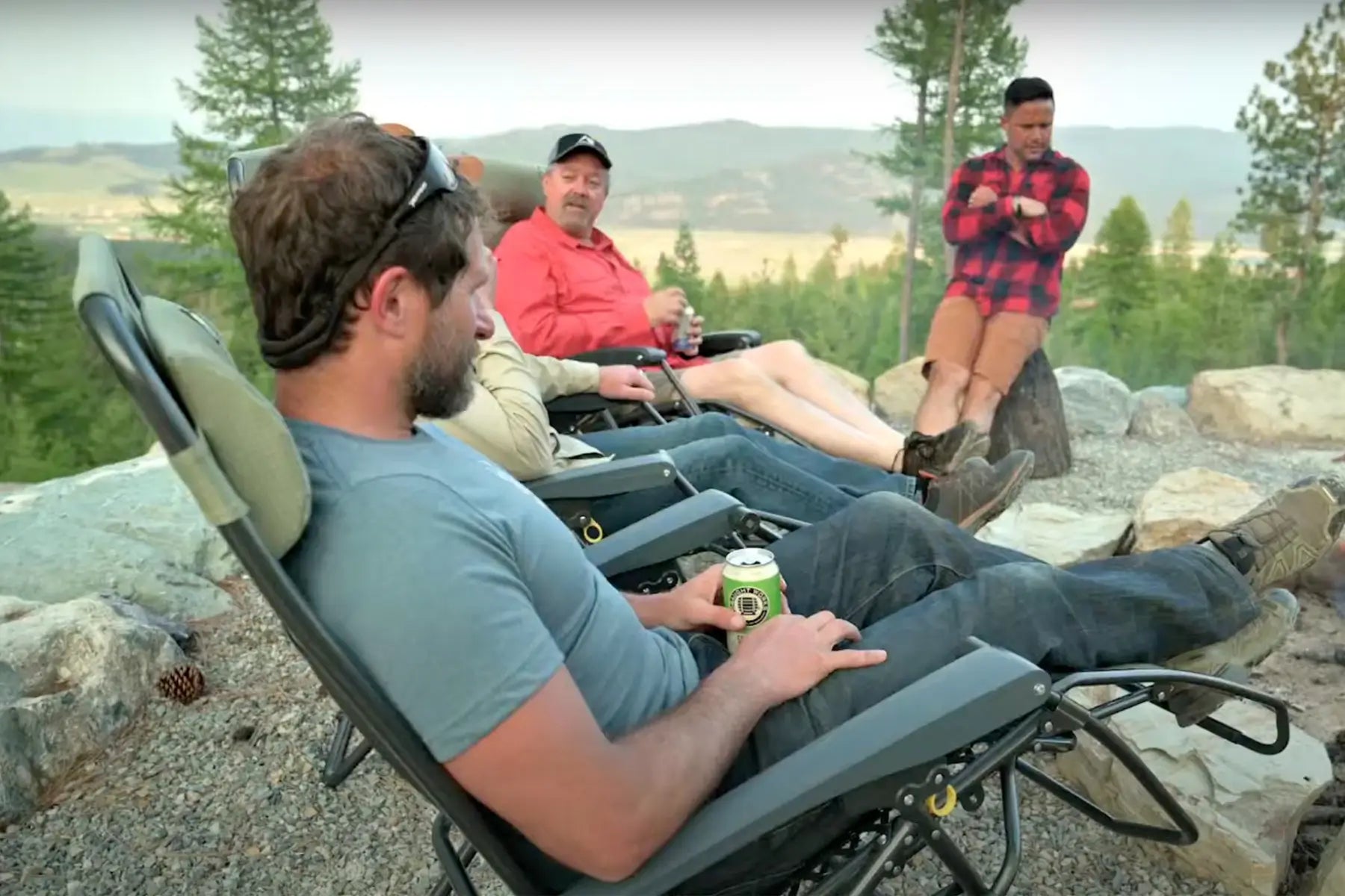 Group of people sitting in GCI Freeform Zero Gravity Lounger chairs, with one person holding a drink.