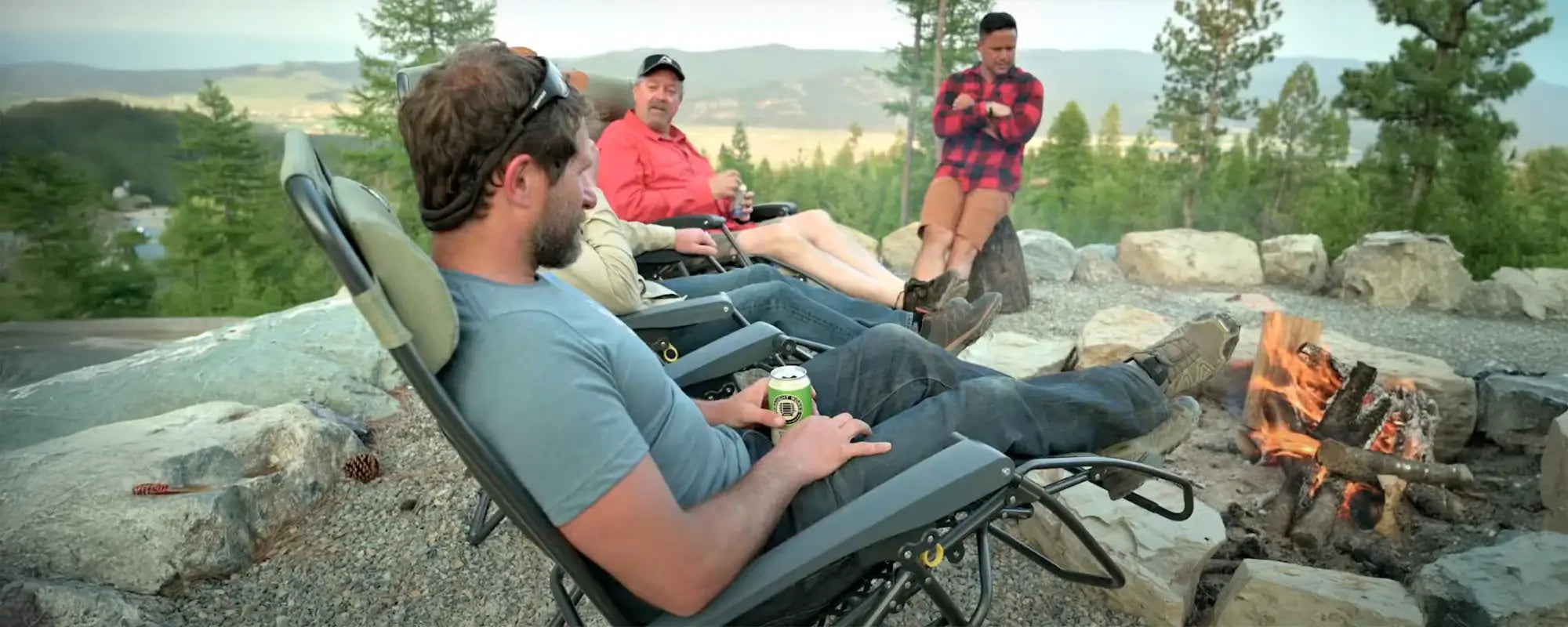 Group of people sitting in GCI Freeform Zero Gravity Lounger chairs, with one person holding a drink.