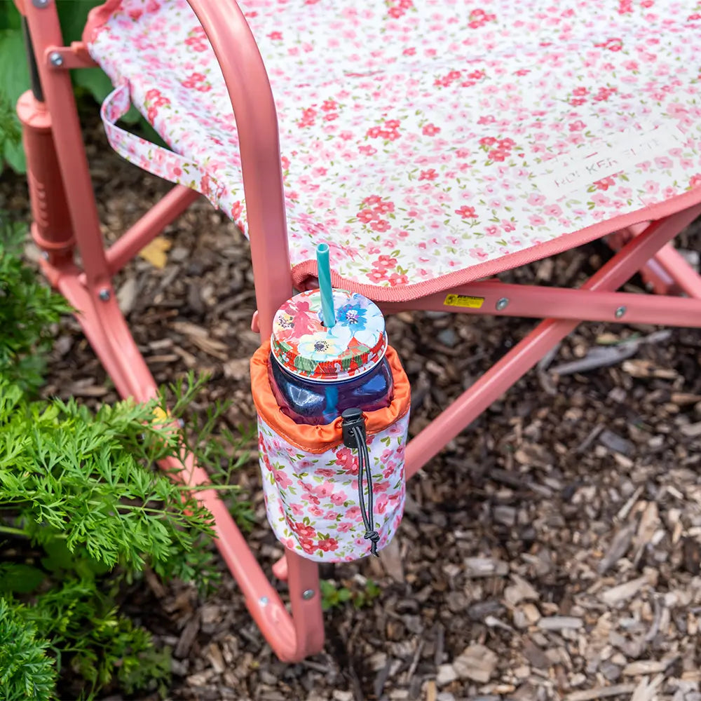 A mason jar in the attached cup holder of the pink sundress freestyle rocker elite. 