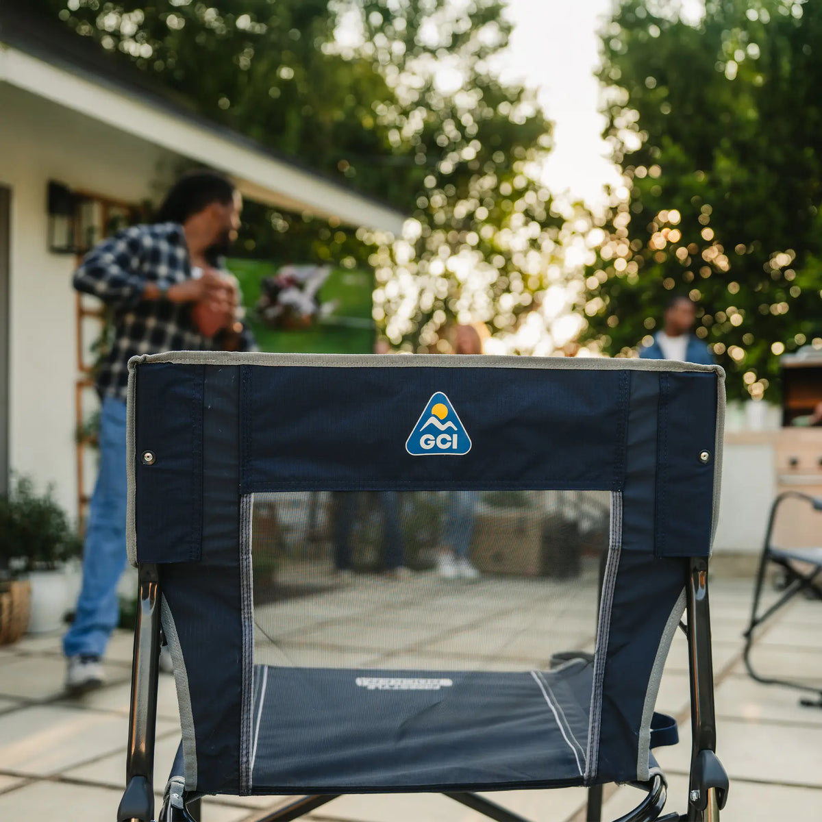 The backside of an indigo freestyle rocker showing the GCI logo and mesh backrest. 