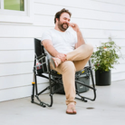 A man laughing and sitting in a black Freestyle Rocker XL chair. 