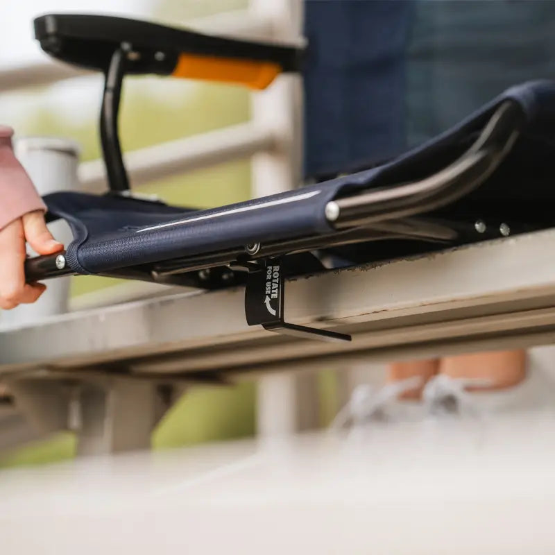 Close-up of a GCI Outdoor Stadium Rock-Cliner’s clamp securing this adjustable rocking seat to a bleacher.