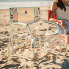 A Grab and Go Rocker floral bouqet on a sandy beach. 