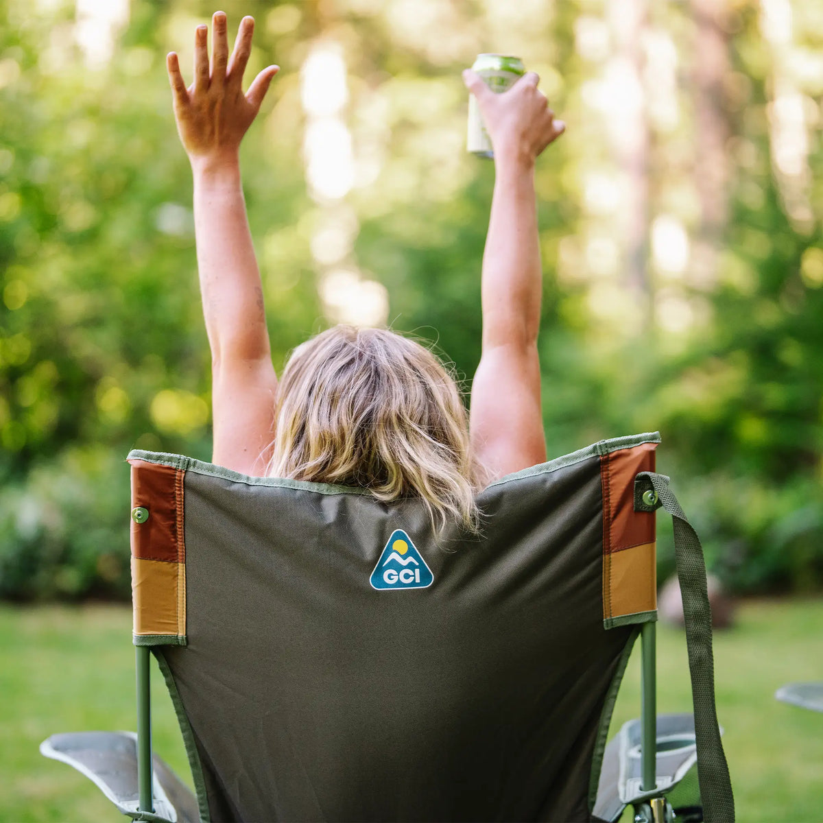 A woman throwing her hands in the air as she sits in an Insulated Comfort Pro Rocker. 