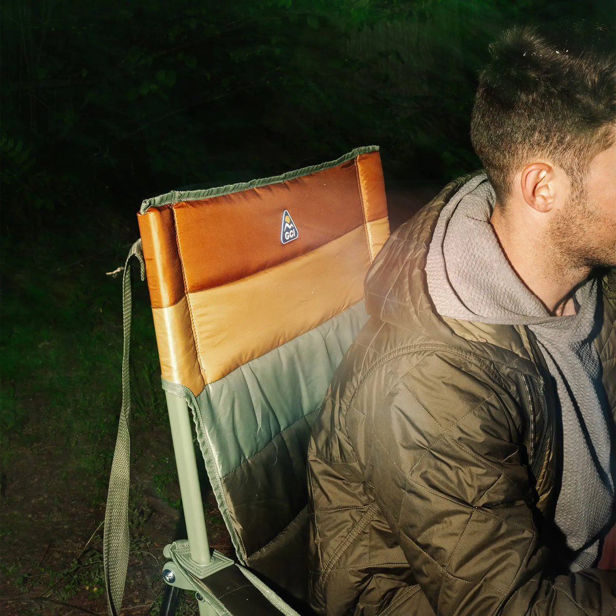 An up close view of the backrest of the Insulated Comfort Pro Rocker with a man sitting in it leaning forward. 