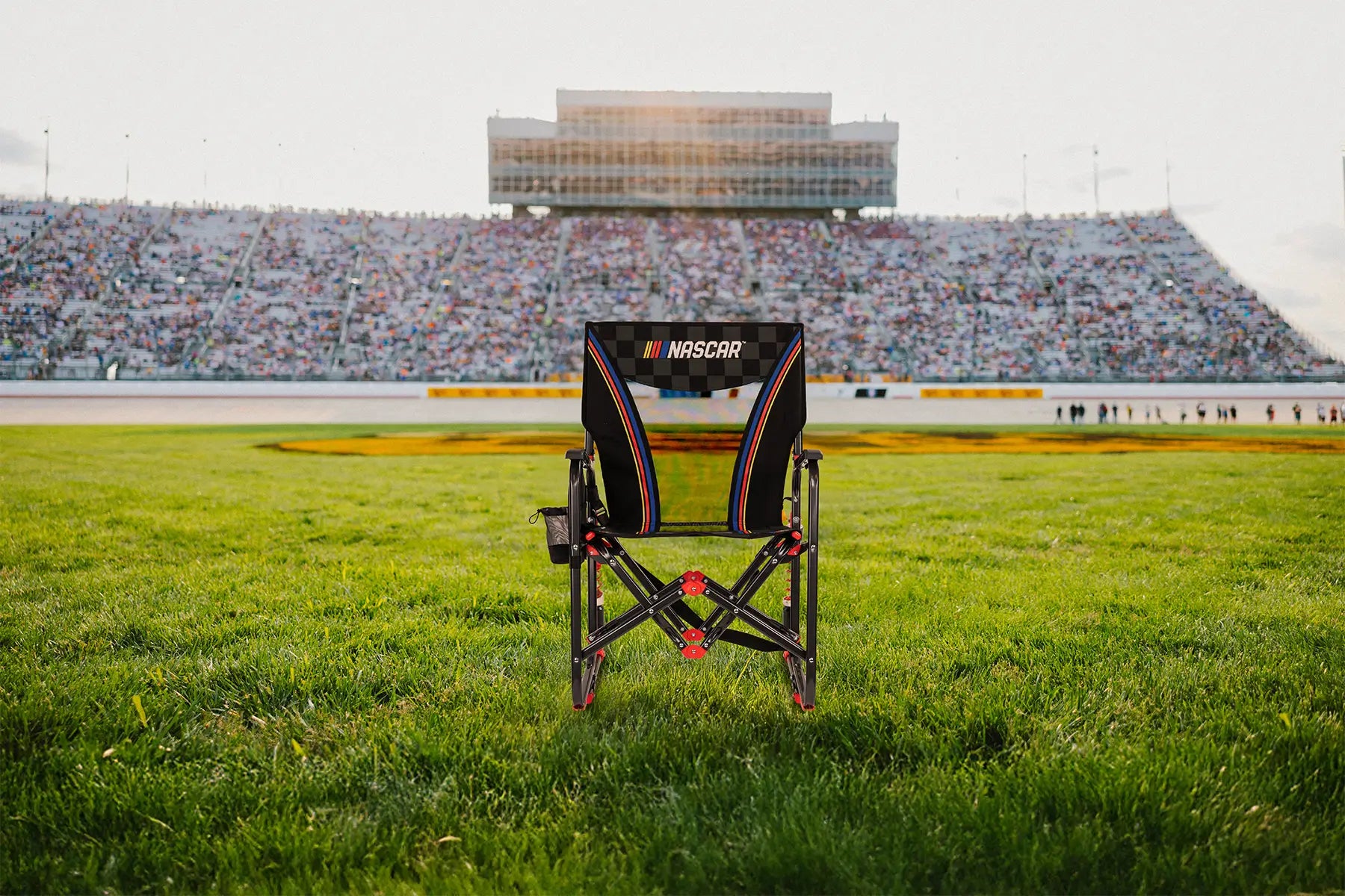 A NASCAR Adjustable Rocker positioned in front of a racetrack. 