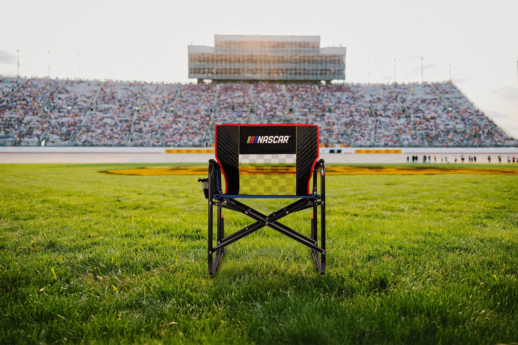 A NASCAR Freestyle Rocker XL positioned in front of a racetrack. 