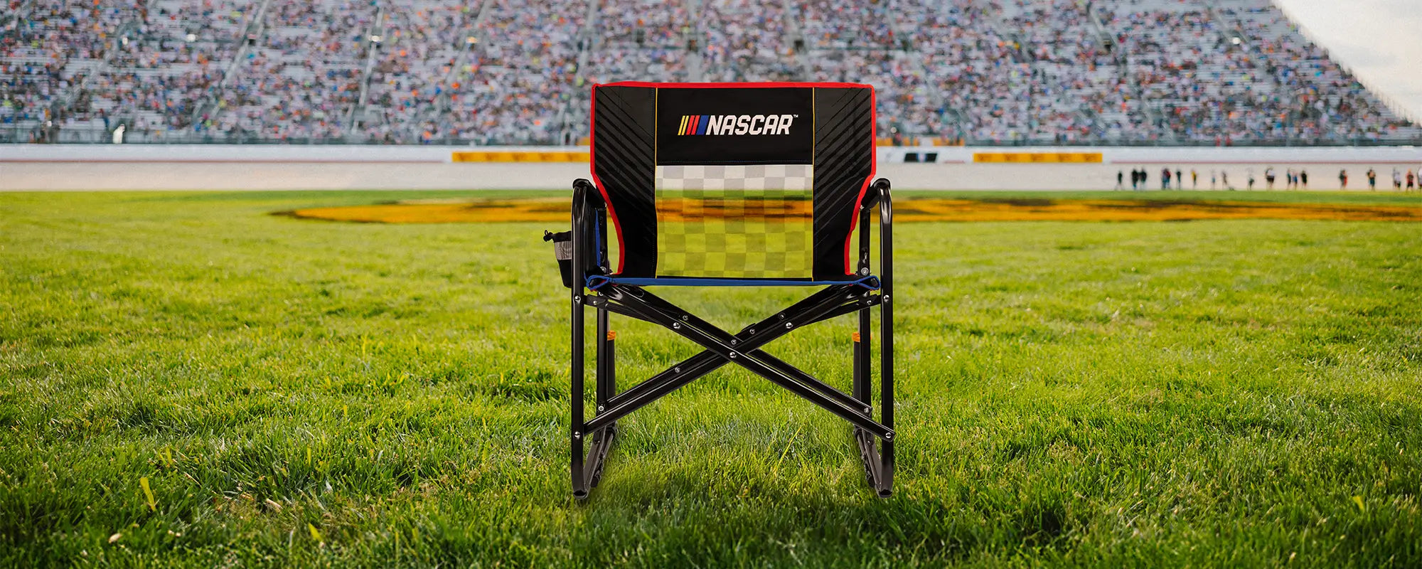 A NASCAR Freestyle Rocker XL positioned in front of a racetrack. 
