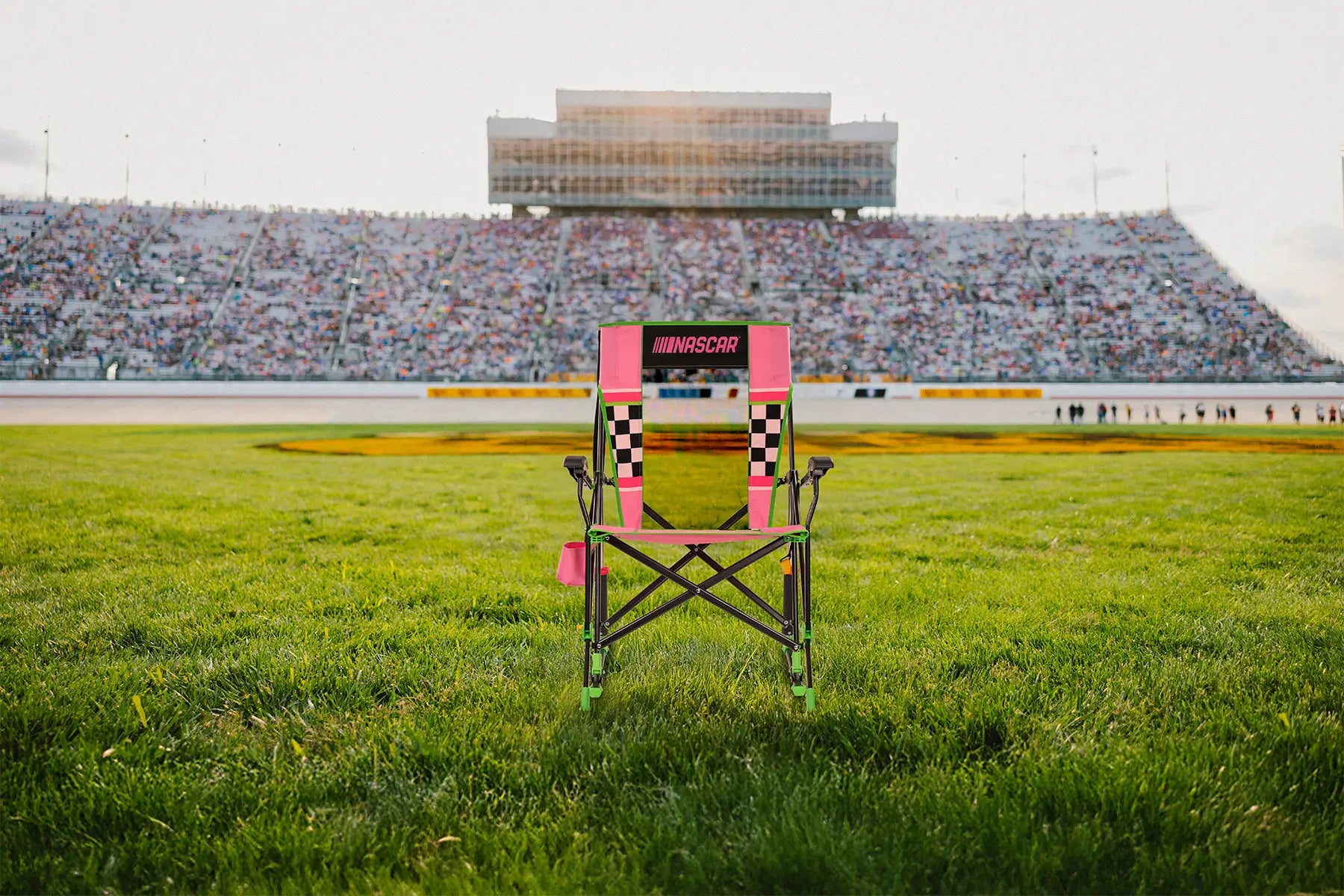 A NASCAR Roadtrip Rocker positioned in front of a racetrack. 