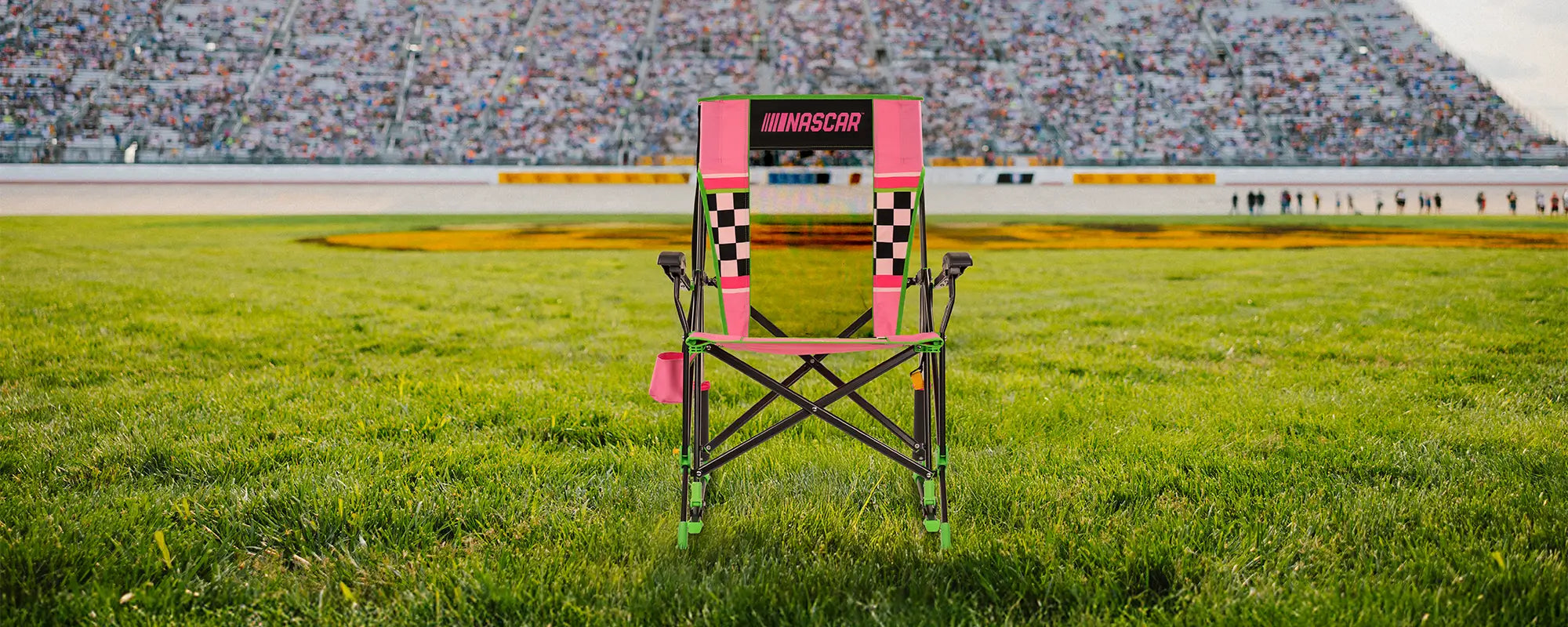 A NASCAR Roadtrip Rocker positioned in front of a racetrack. 