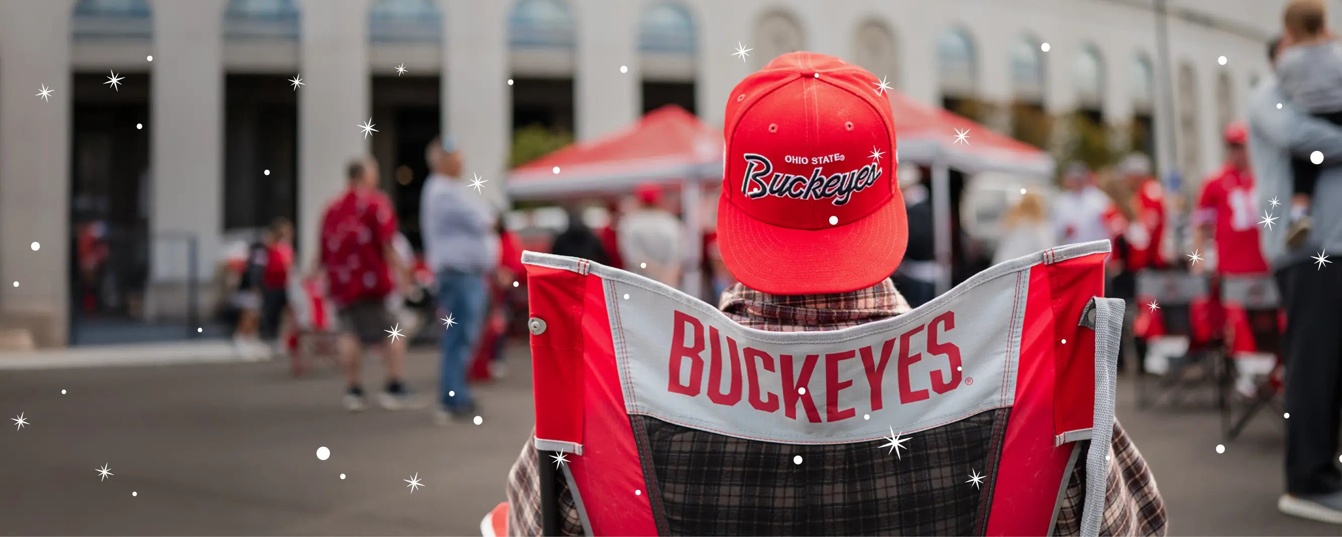 A man with a buckeyes hat on sitting in a comfort pro rocker buckeyes printed chair. 