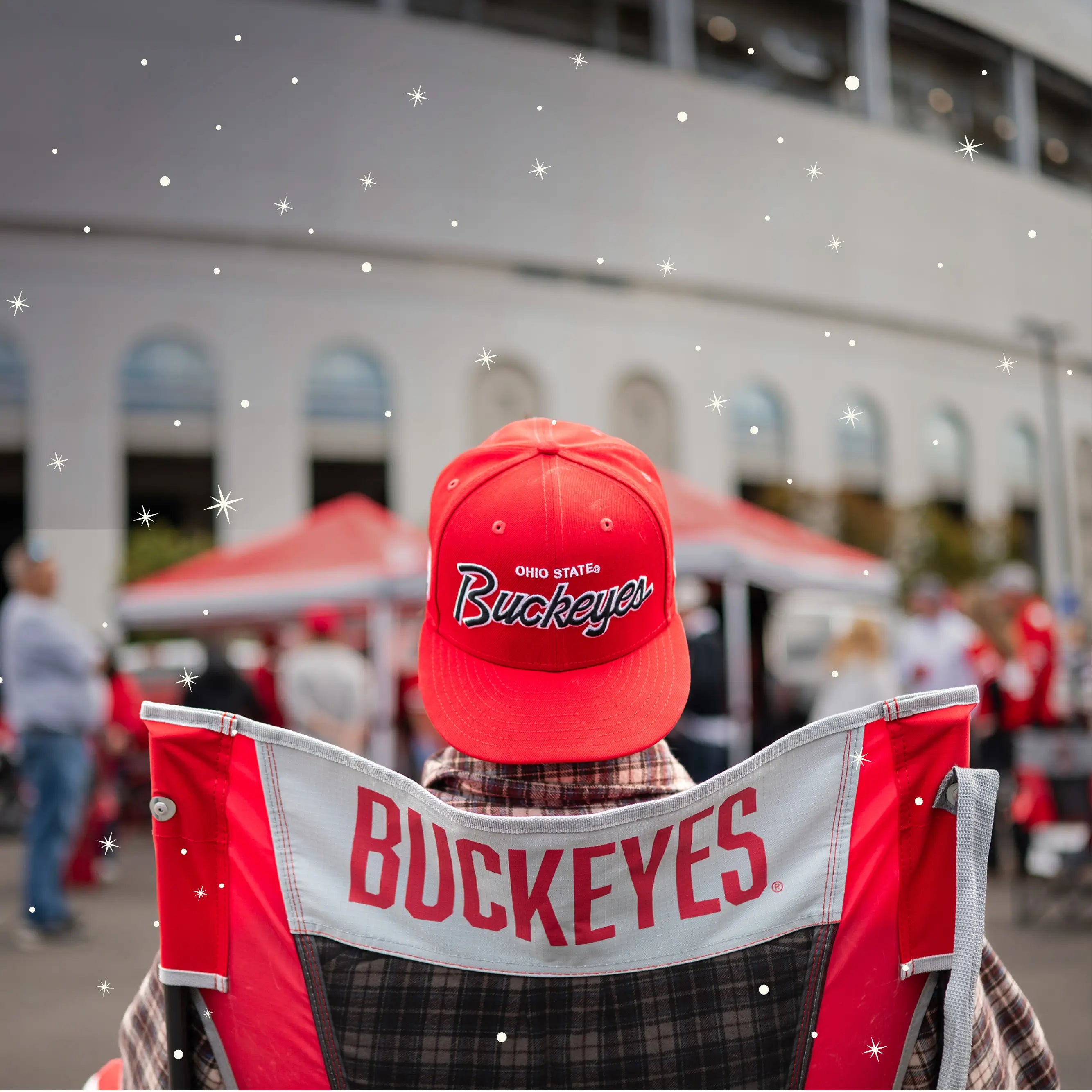 A man with a buckeyes hat on sitting in a comfort pro rocker buckeyes printed chair. 