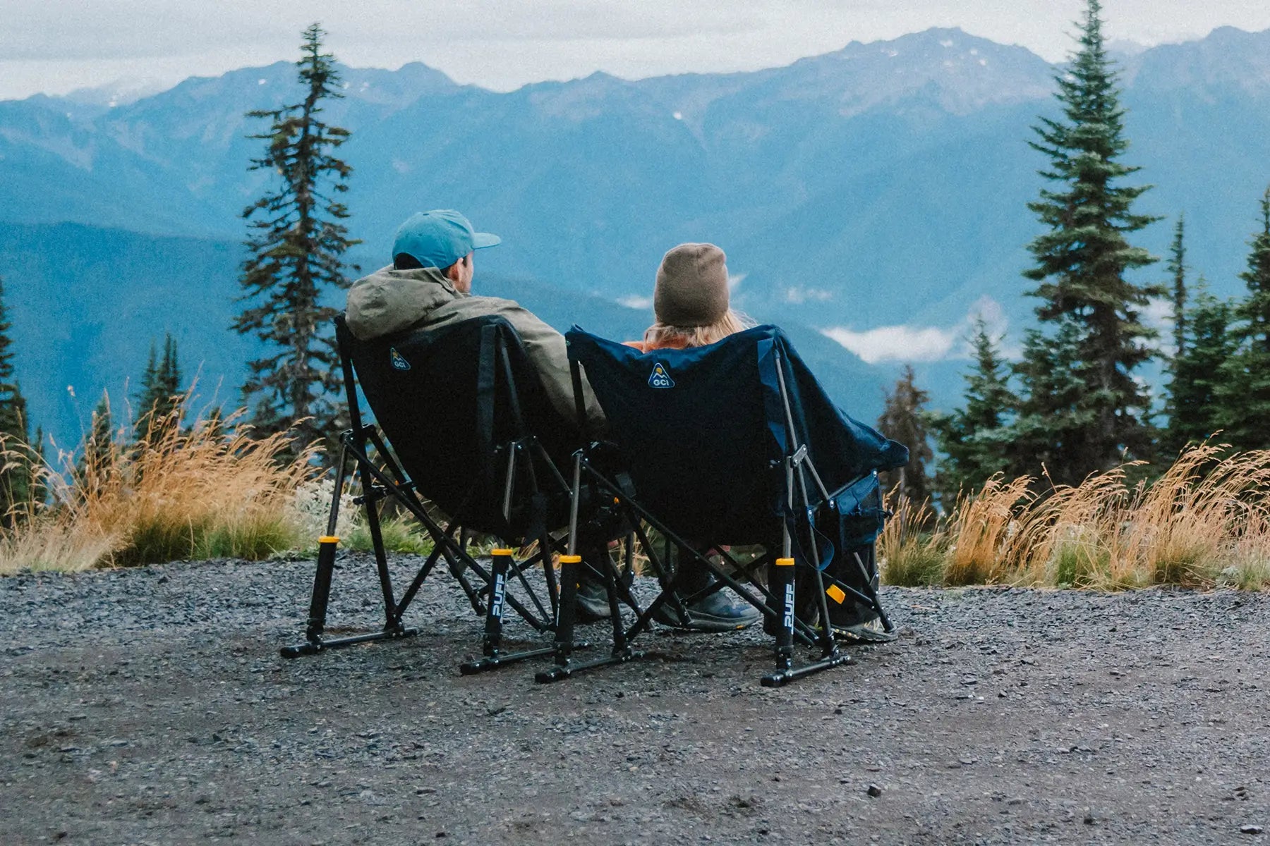 A couple looking at an overlook while sitting in their puff rocker chairs. 