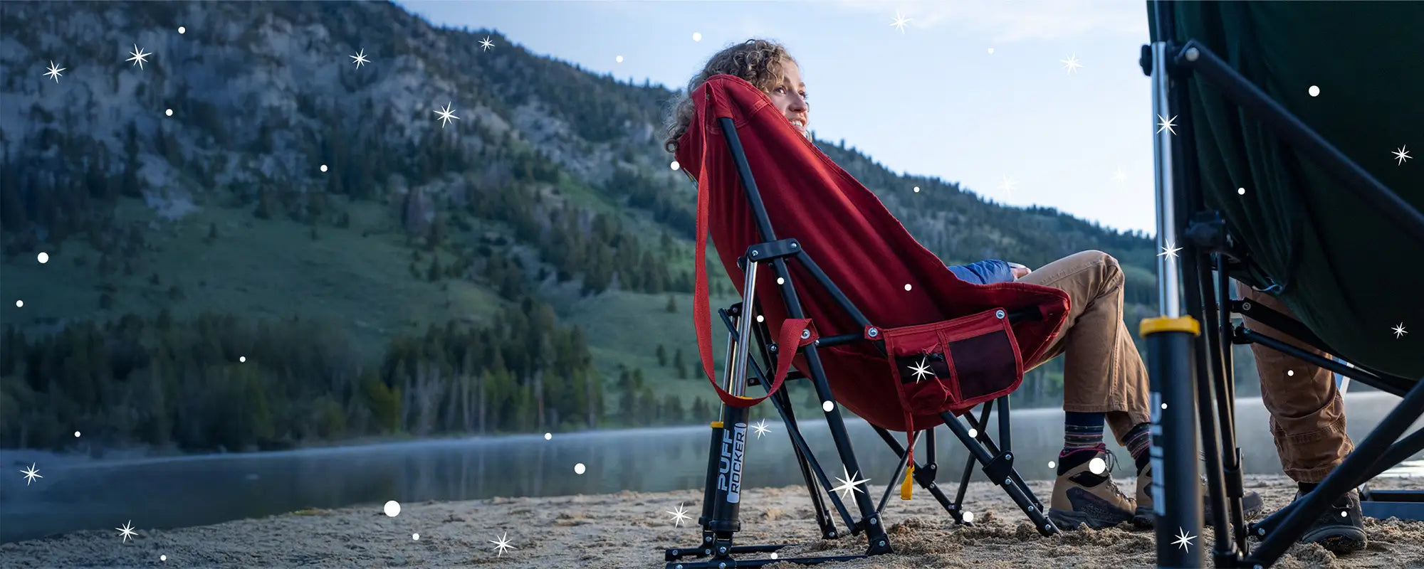 A woman sitting in a puff rocker next to a body of water. 