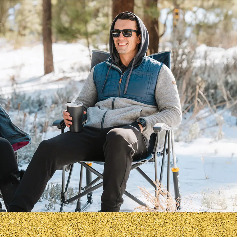 A man with a hoodie sitting in a roadtrip rocker chair. 
