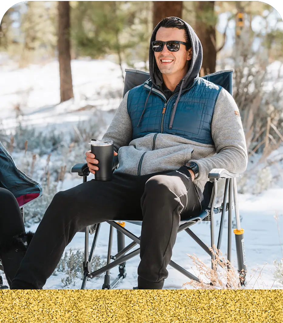 A man with a hoodie sitting in a roadtrip rocker chair. 