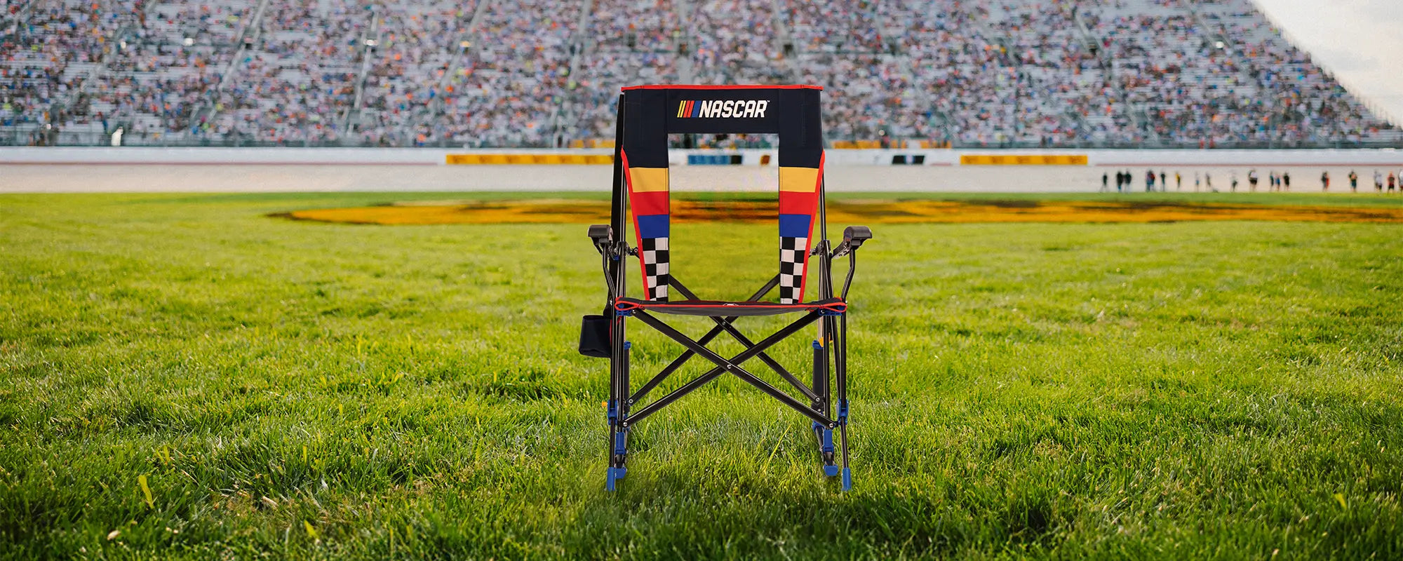 A NASCAR Roadtrip Rocker positioned in front of a racetrack. 