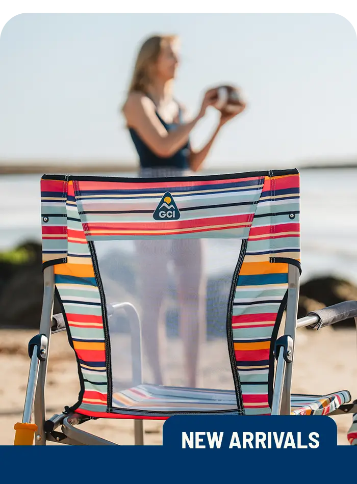 A colorful Beach Rocker chair sits on the sand with a blurred person holding a ball in the background. "New Arrivals" label at the bottom.