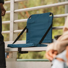 all-groups SitBacker securely installed on bleachers, with padded seat and backrest upright and ready for use.