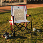 A baseball Stowaway Rocker positioned on a baseball field next to several baseballs and a baseball glove. 