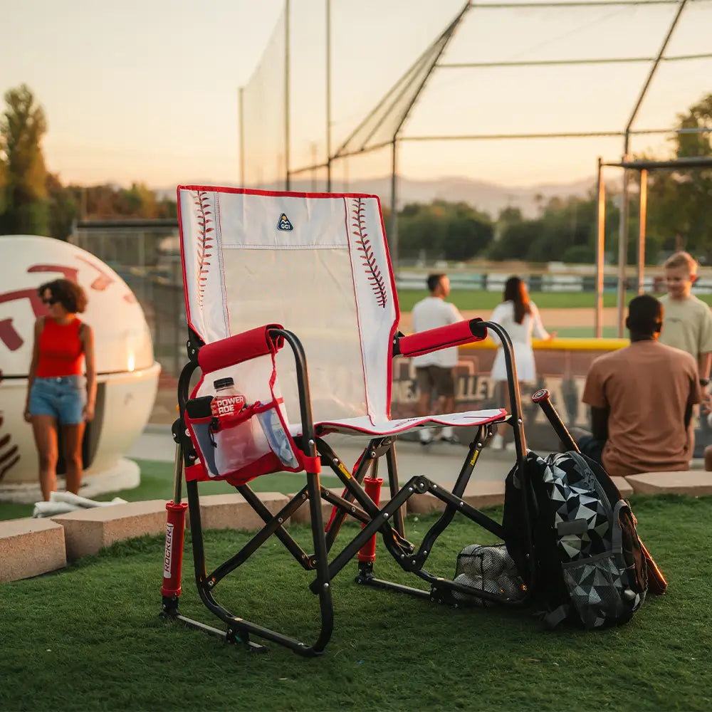 An unfolded stowaway rocker baseball print positioned near a baseball field. 