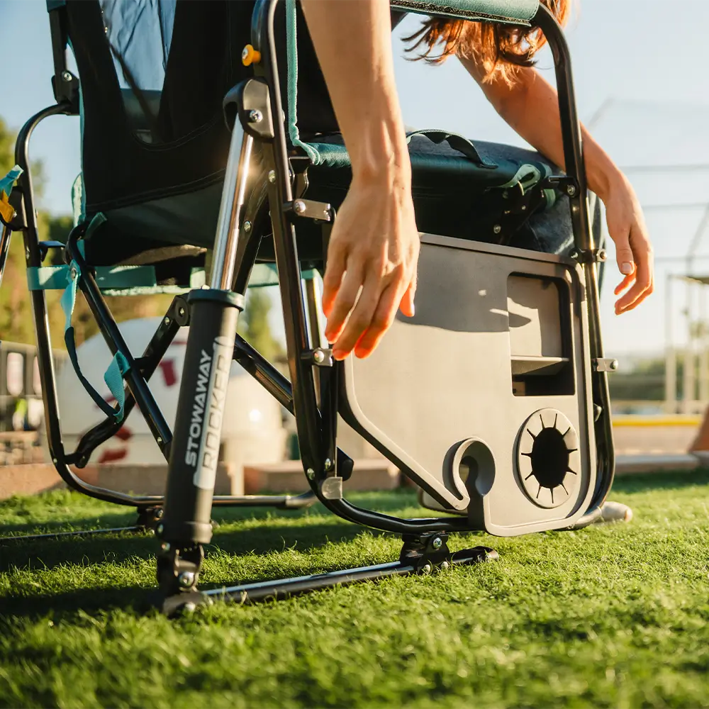 Person reaching down to access the built-in storage/cooler area on a Teal Stowaway Rocker with Side Table