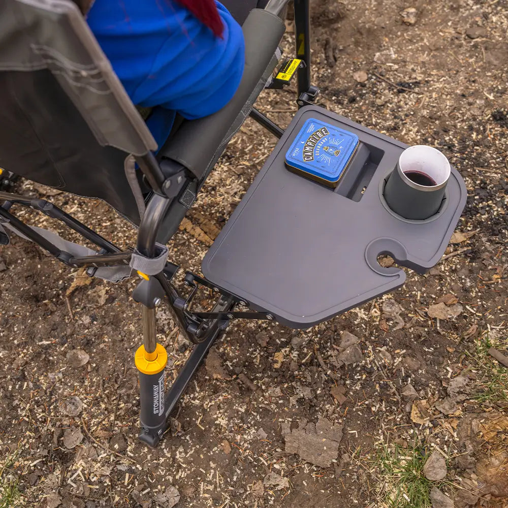 Overhead view of the side table on the Black Stowaway Rocker holding a mug and personal items outdoors.