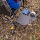 Overhead view of the side table on the Black Stowaway Rocker holding a mug and personal items outdoors.