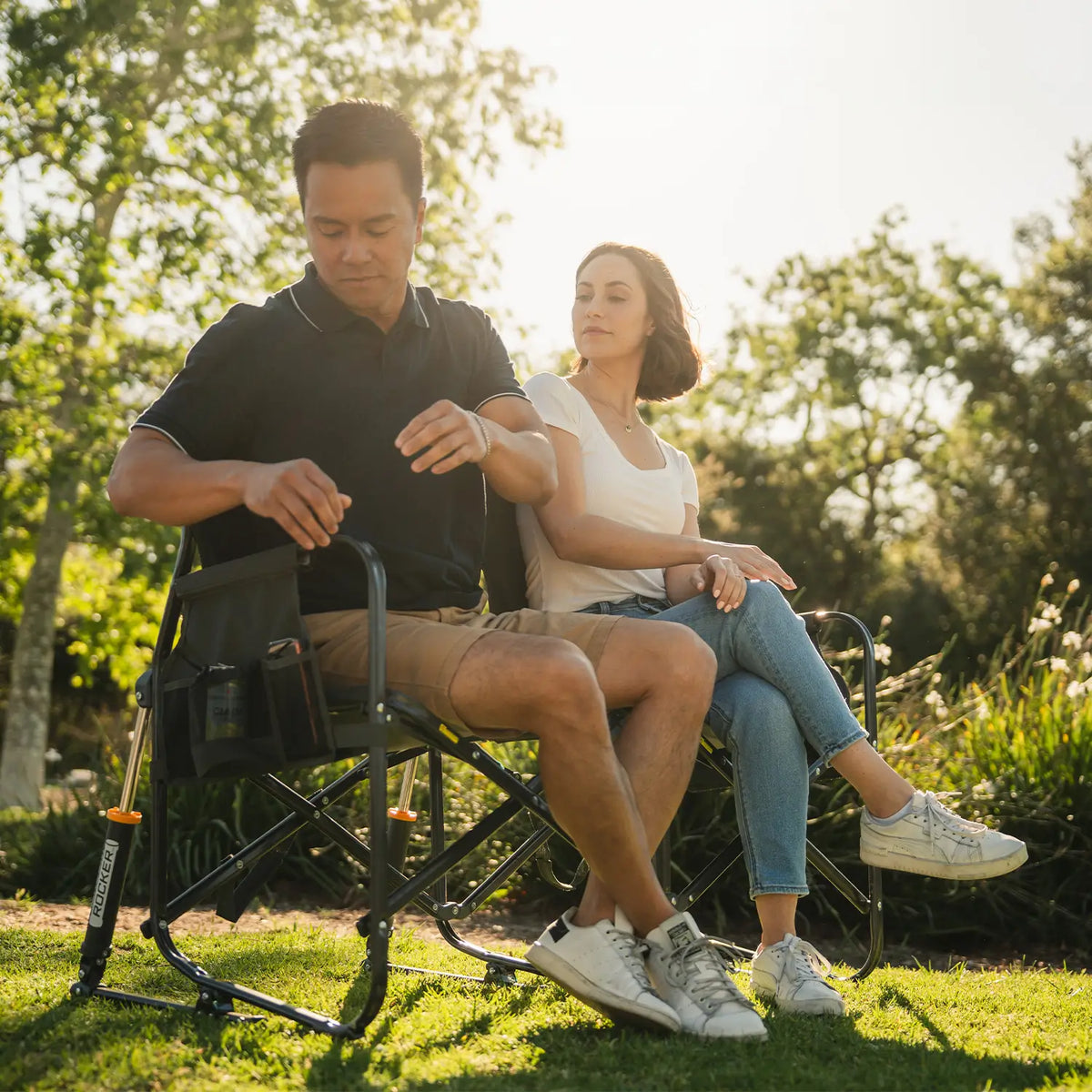 A man reaching for his phone in the phone holder of the Tandem Rocker. 