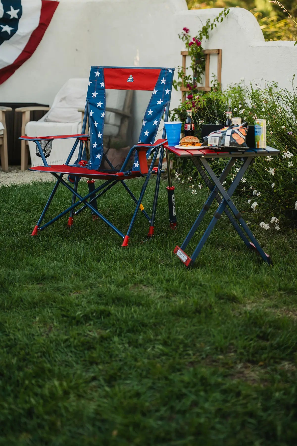 A USA Comfort Pro Rocker and USA table in a backyard setting. 