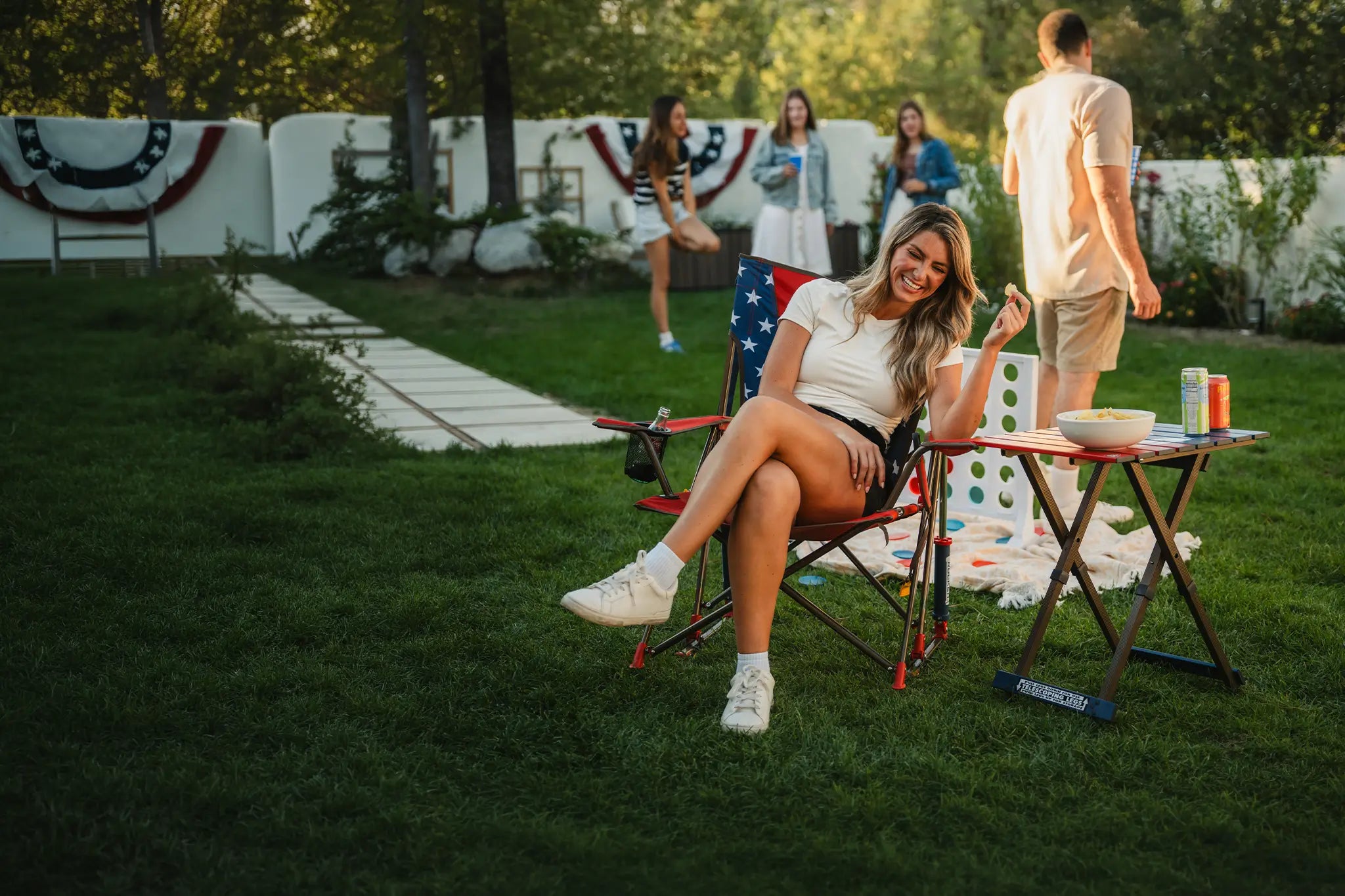 A USA Comfort Pro Rocker and USA table in a backyard setting. 